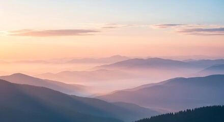 Layered mountain ranges under a pastel sky with light fog in the valleys view