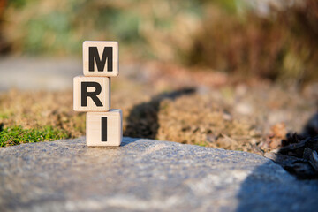 MRI - text on cubes standing on a stone on a natural background