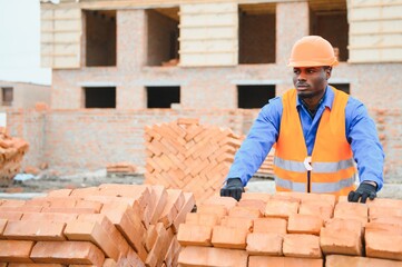 African american Construction worker in uniform and safety equipment have job on building....