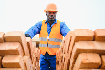 Construction african american worker in uniform and safety equipment have job on building.
