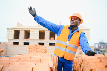 Construction african american worker in uniform and safety equipment have job on building.