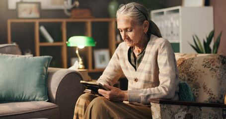 Grief, old woman and sad with picture frame in home for mourning, remember and lonely in...