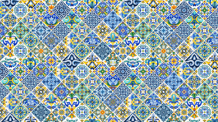 An intricate mosaic pattern featuring blue yellow and green floral tile designs on a white background