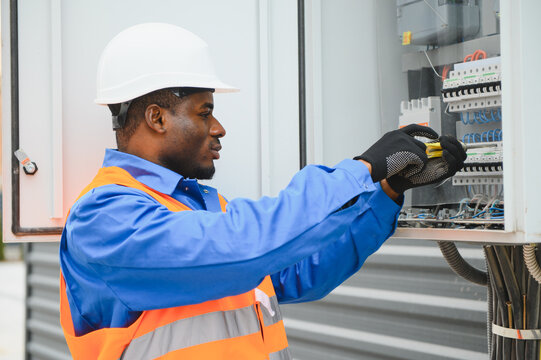 African american Electrical engineer approving power distribution box installation on site