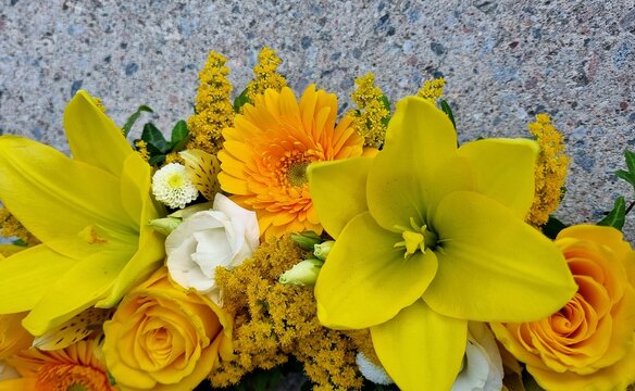 Ritual decor round for memorial events. Floral arrangement in the shape of a circle with white and yellow flowers, including roses, eustoma and lilies, gerberas, chrysanthemums, solidago, leaves