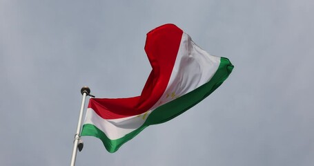 Tajikistan Flag 4K video. Tajikistan flag fluttering against blue sky, national symbol of Tajikistan. Independence Day. Flag, close-up. Great for news.