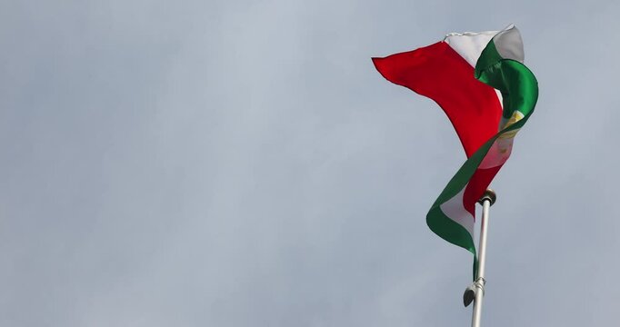 Tajikistan Flag 4K video. Tajikistan flag fluttering against blue sky, national symbol of Tajikistan. Independence Day. Flag, close-up. Great for news. - Powered by Adobe