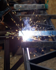 A man is welding a piece of metal