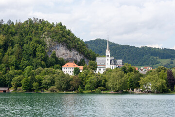A picturesque view across the serene waters of Lake Bled, showcasing the charming town of Bled...