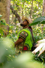Portrait of a Costa Rican Latino man in a colorful Caribbean shirt looking at animals in Cahuita National Park, Costa Rica