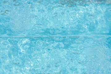 Blue water with ripples on the surface. Defocus blurred transparent blue colored clear calm water...