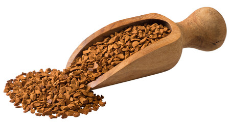 Freeze dried coffee powder in a wooden scoop, isolated on a white background.