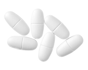 White oval pills isolated on white background, top view.