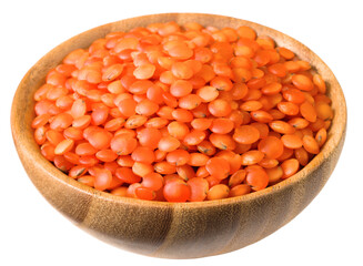 Uncooked red lentils in the wooden bowl, isolated on white background.