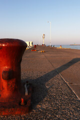 bollard in the foreground with a port in the background 