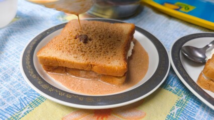 Viral Dubai chai toast trending on internet, freshly made with bread filled with malai milk cream, soaked in hot spiced tea. A nostalgic and viral comfort food