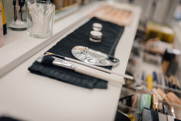 Makeup brushes and palette resting on countertop ready for beauty application