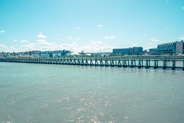 Peaceful waterfront view in Rouen France showcasing the architectural beauty along the riverbank on a sunny day