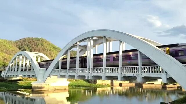 The train is running across a bridge over a river.