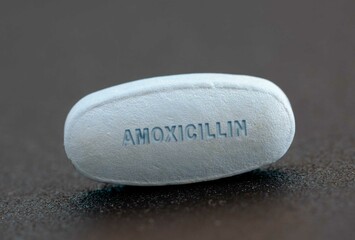Close-up of Amoxicillin Tablet with Text "AMOXICILLIN" Used for Treating Bacterial Infections