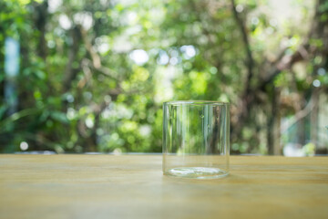 Empty glass ready to use placed on wood table against nature background