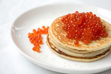 Stack of pancakes with a pile of red berries on top