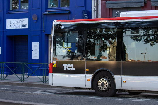 France, 13 May 2025 : City bus passes by blue bookstore named La Procure