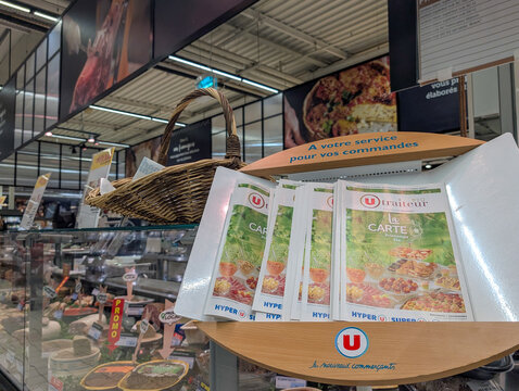 France, 03 May 2025 : Grocery store display of catering menus and promotional deli food products
