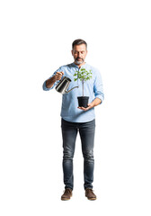 Man watering a small tree