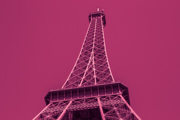 colored in pink color Eiffel tower in Paris against magenta sky