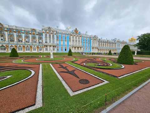ST-PETERSBURG - JUN 20, 2024: Large building in Catherine Palace in Tsarskoe Selo, Saint-Petersburg with a blue roof and a blue and white facade. The building has a courtyard with a statue in middle