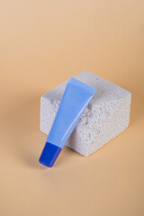 Purple packaging for cream, sunscreen or serum on with stylish props on cream background.