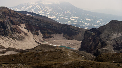 Majestic mountain landscape showcasing rugged terrain, snow-capped peaks, and a serene glacial lake...