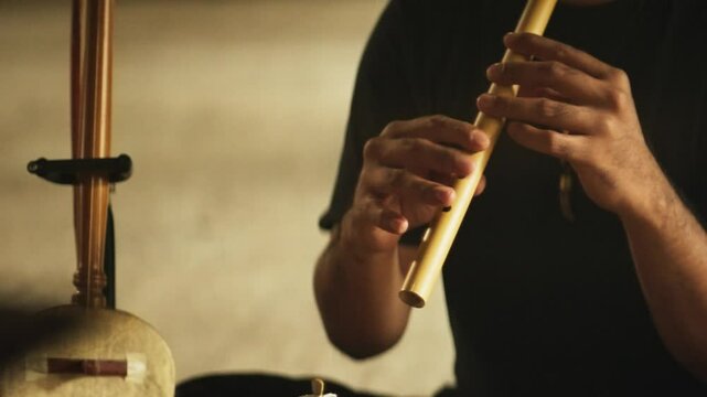 Close-Up of Hands Playing a Bamboo Flute &ndash; Traditional Indonesian Wind Instrument Performance