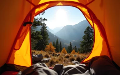 Fotobehang POV from a camping tent: A view from inside an orange tent, looking out at the beautiful mountain landscape with trees and a clear sky in the autumn. High quality © nana
