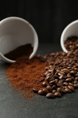 Aromatic ground coffee and beans on black table, closeup