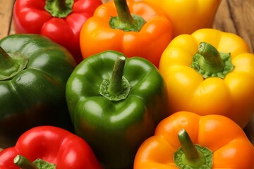 Fresh colorful bell peppers on table, closeup