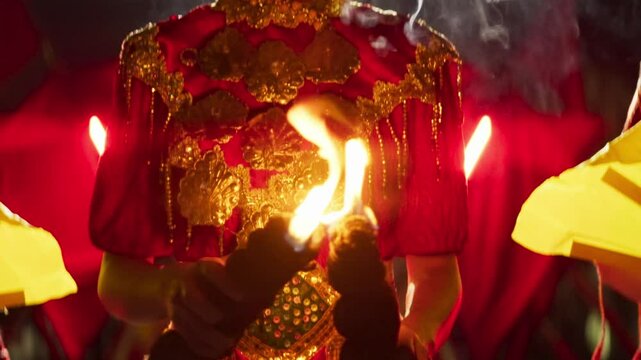 Close-Up of a Bugis Fire Dancer's Hand Lighting a Torch with a Matchstick &ndash; Traditional Fire Performance Preparation