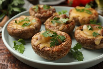 Many tasty stuffed mushrooms on table, closeup