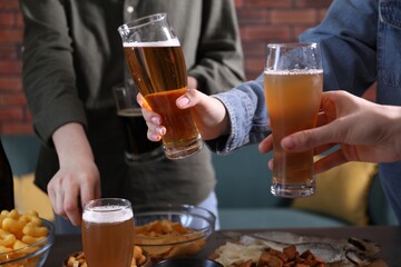 Friends with beer and snacks at table, closeup