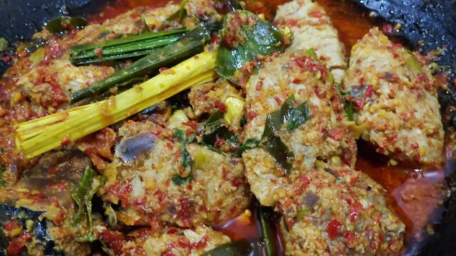 close up of a painting,Skipjack tuna woku ,Fish woku a typical fish dish from Manado ,North Sulawesi,Woku is an Indonesian type of bumbu or spice mixture found Manado cuisine,authentic Manado sauce