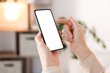Woman using modern smartphone at home, closeup
