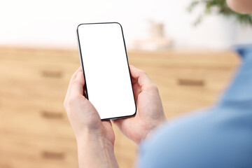 Woman using modern smartphone at home, closeup