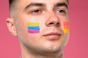 Portrait of a Man with Colorful Face Paint in Support of Pride