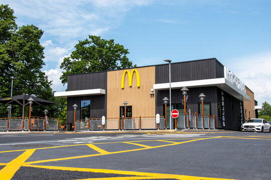 Exeter, Devon, uk. 06-23-25. A newly opened McDonalds store. The latest design of the fast food outlet McDonalds showing the drive through in use. Burgers and fries. 