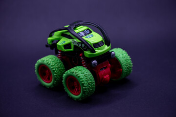 Childrens toy cars green monster truck dark surface suitable for kids birthday party invitations, toy store advertisements, childrens books.
