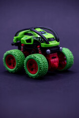 Green toy monster truck, perfect for childrens toy advertisements and designs for kids room decor or clothing patterns. Fun and colorful.