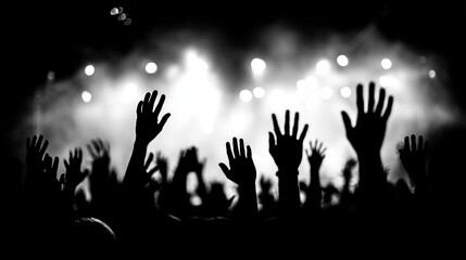 Silhouetted hands raised in excitement at a vibrant concert