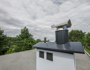 Chimney and ventilation system on the roof of the building