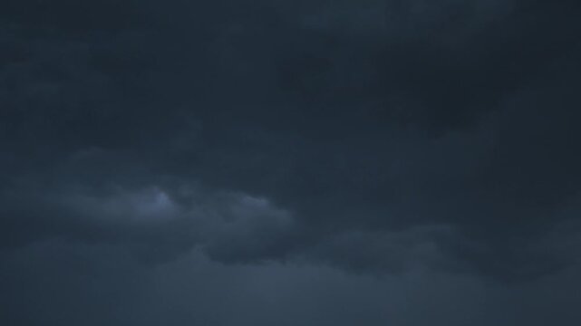 Dark clouds gather ominously over the horizon as evening approaches